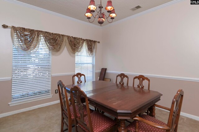 dining room featuring light colored carpet, ornamental molding, a textured ceiling, and an inviting chandelier