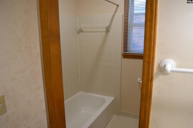 bathroom featuring tile patterned flooring and tiled shower / bath combo