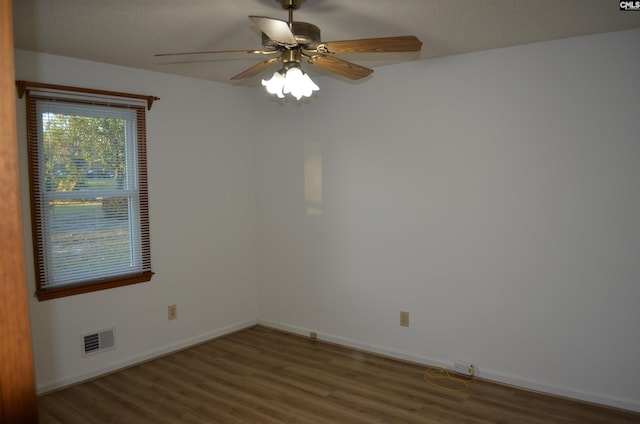 unfurnished room with dark hardwood / wood-style flooring and ceiling fan