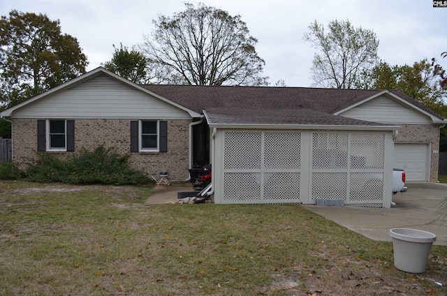 single story home with a garage and a front lawn