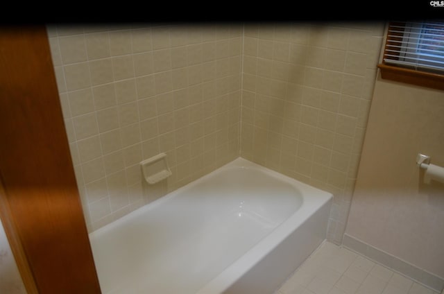 bathroom featuring tile patterned floors and a tub to relax in