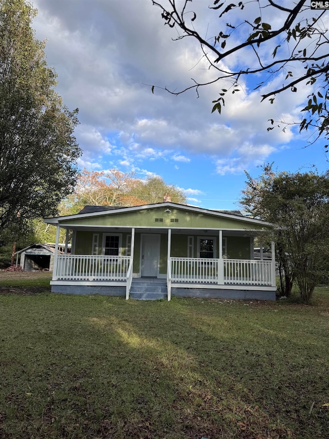 view of front of property with covered porch and a front yard