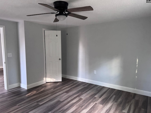 unfurnished room with a textured ceiling, ceiling fan, and dark hardwood / wood-style floors