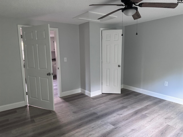 unfurnished bedroom with ceiling fan, hardwood / wood-style floors, and a textured ceiling