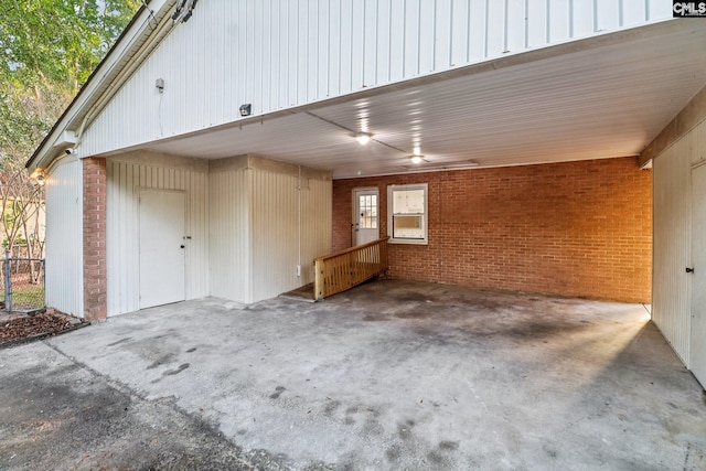 exterior space with concrete flooring and brick wall