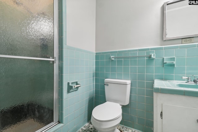 bathroom featuring vanity, tile walls, tile patterned flooring, toilet, and a shower with shower door