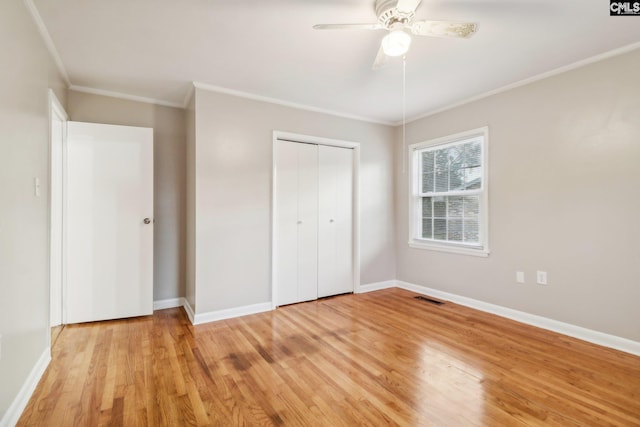 unfurnished bedroom with a closet, light hardwood / wood-style floors, ceiling fan, and ornamental molding