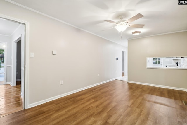 empty room with hardwood / wood-style floors, ceiling fan, and ornamental molding