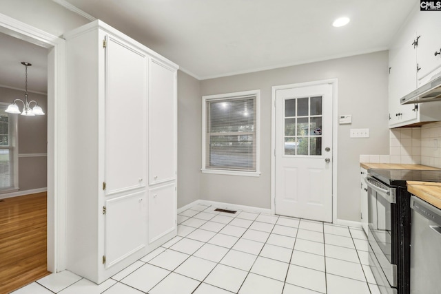 kitchen featuring stainless steel appliances, backsplash, a chandelier, decorative light fixtures, and white cabinets