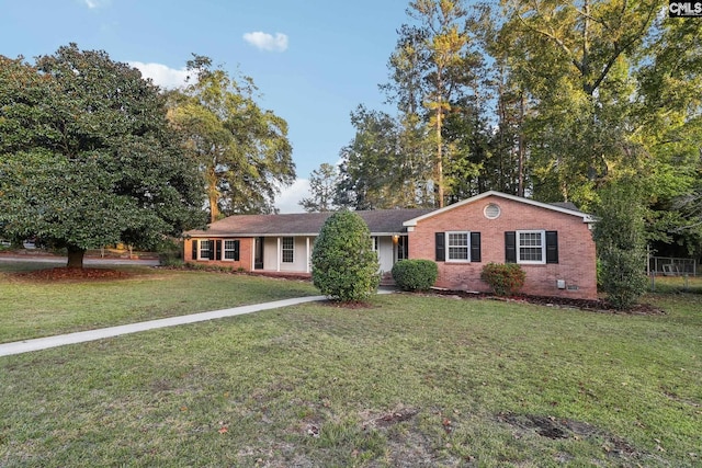 ranch-style home with a front lawn