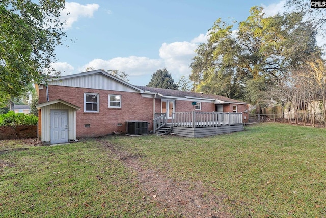 back of house featuring a lawn, central AC, a deck, and a storage shed