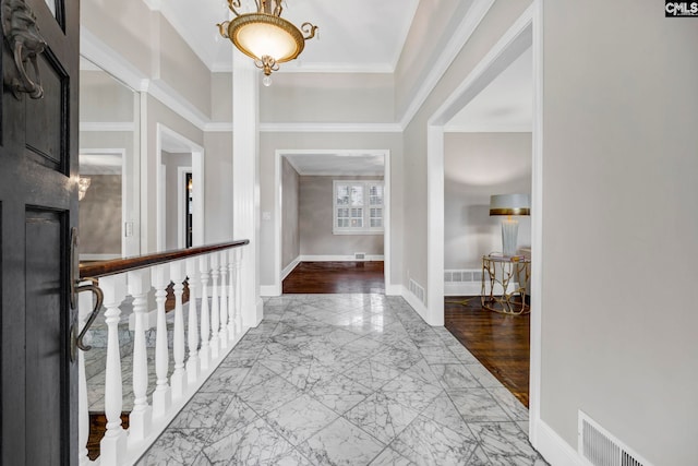 entrance foyer with crown molding and light hardwood / wood-style flooring