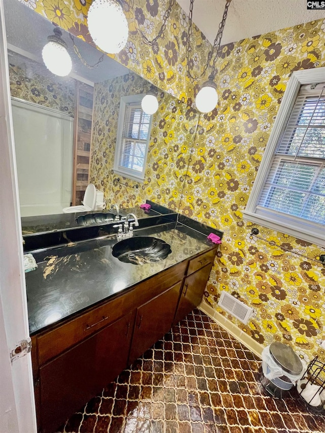 bathroom with a textured ceiling and vanity