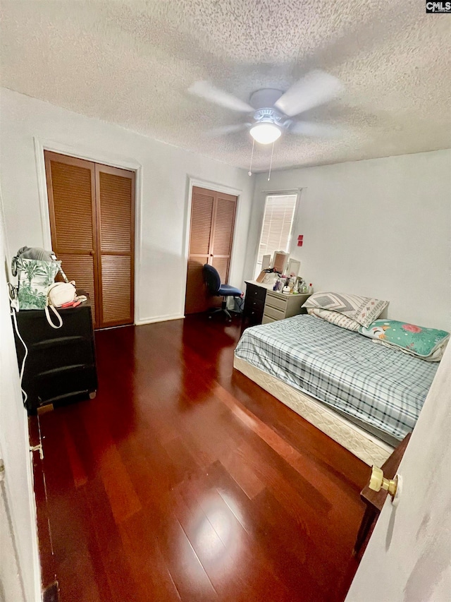 bedroom with hardwood / wood-style floors, a textured ceiling, and ceiling fan