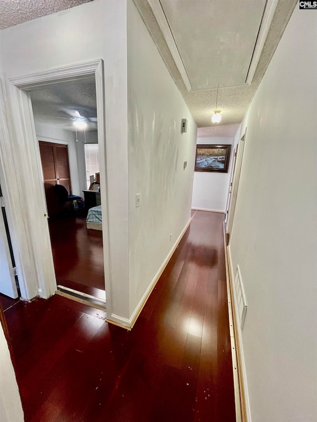 hall featuring hardwood / wood-style floors and a textured ceiling