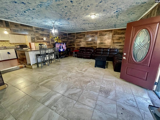 interior space featuring sink and wood walls