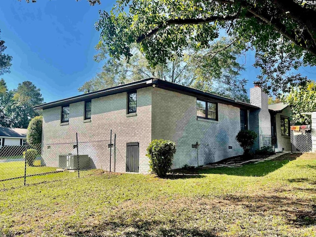 view of side of home with a lawn