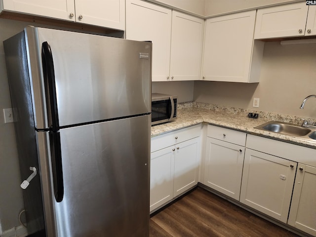 kitchen featuring white cabinetry, sink, appliances with stainless steel finishes, and dark wood-type flooring