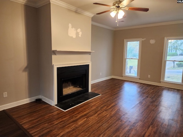 unfurnished living room with ceiling fan, crown molding, and dark wood-type flooring