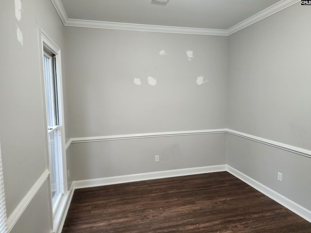 empty room with dark hardwood / wood-style flooring and crown molding