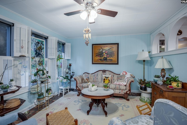 living room featuring ceiling fan and ornamental molding