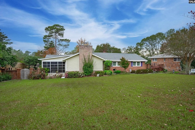 back of property with a lawn