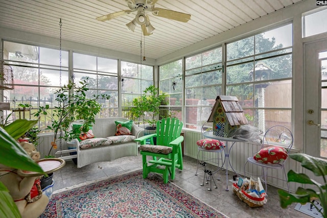 sunroom featuring ceiling fan and wood ceiling