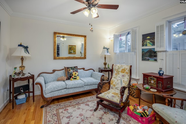 living room featuring crown molding, light hardwood / wood-style flooring, and ceiling fan