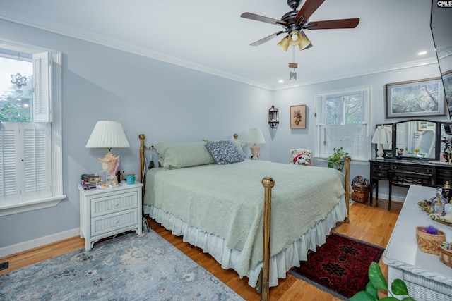 bedroom with ceiling fan, ornamental molding, and light wood-type flooring