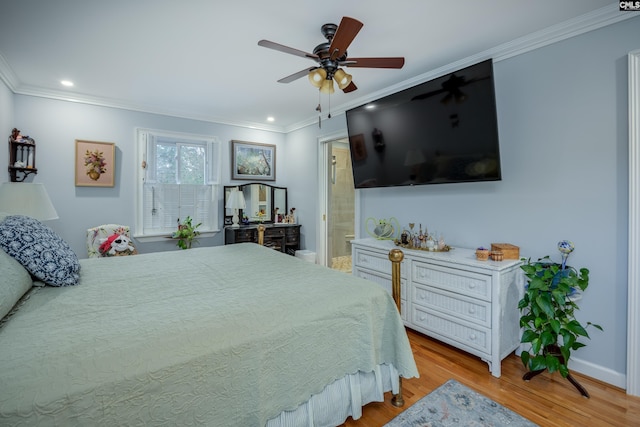 bedroom featuring ceiling fan, ensuite bathroom, light hardwood / wood-style floors, and ornamental molding