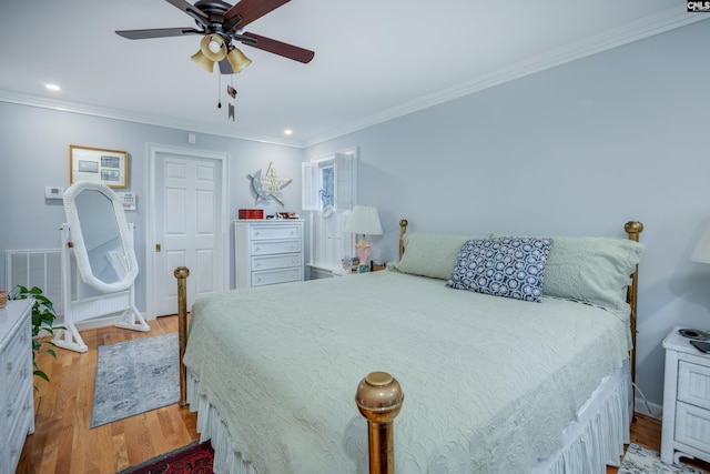 bedroom with ceiling fan, ornamental molding, and light hardwood / wood-style flooring