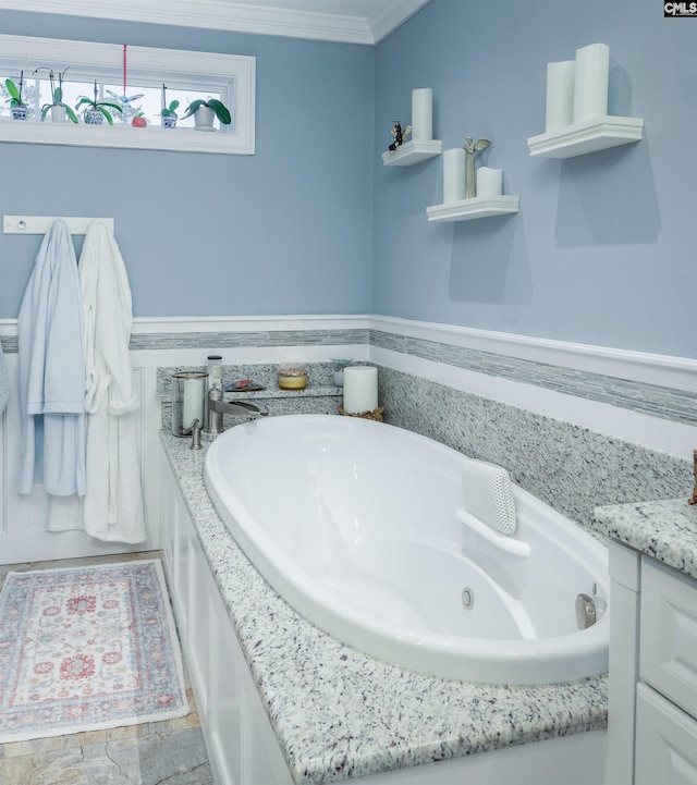 bathroom with vanity, a tub to relax in, and crown molding