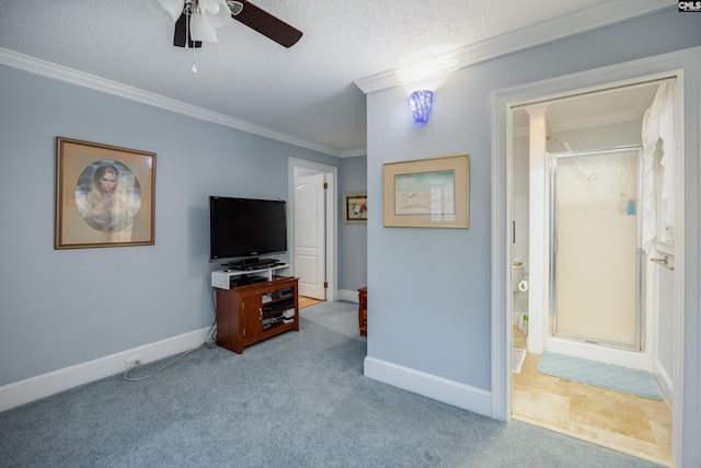 living room featuring light carpet, ceiling fan, a textured ceiling, and ornamental molding