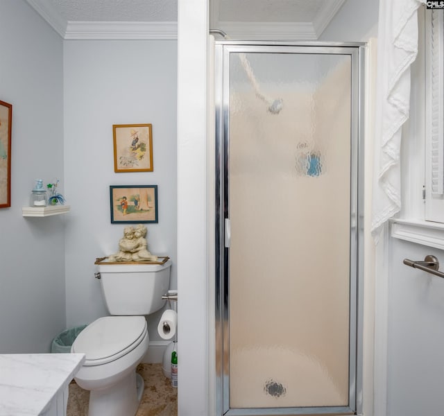 bathroom featuring a textured ceiling, toilet, a shower with door, and ornamental molding