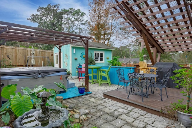 view of patio featuring a pergola, a wooden deck, a grill, and a hot tub