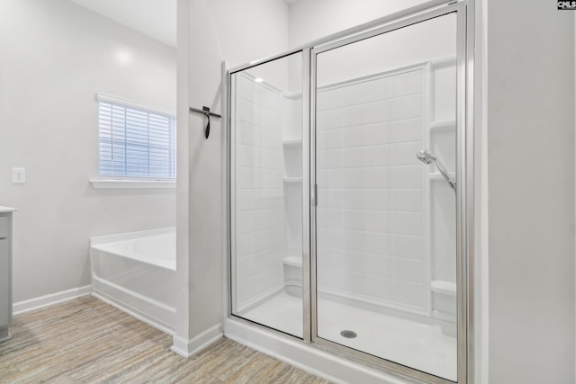 bathroom with wood-type flooring, vanity, and separate shower and tub