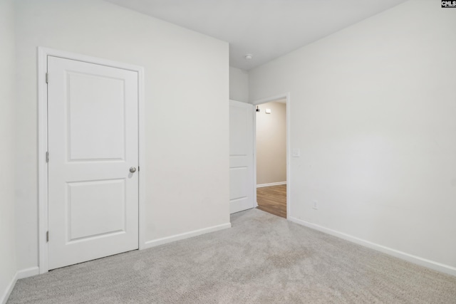 unfurnished bedroom with light colored carpet