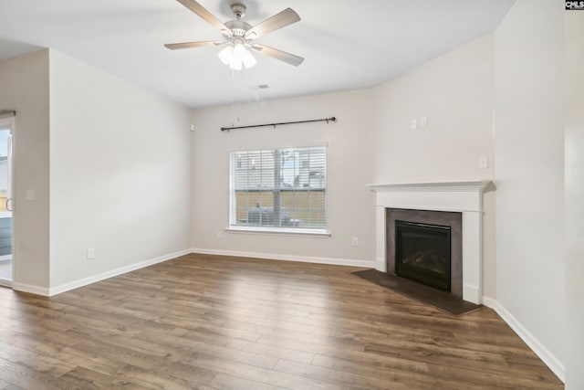 unfurnished living room featuring ceiling fan and dark wood-type flooring