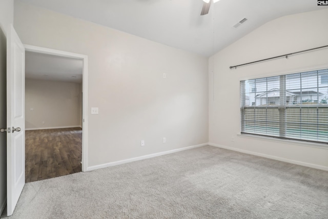 empty room featuring ceiling fan, light colored carpet, and vaulted ceiling