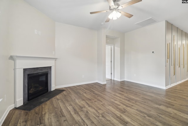 unfurnished living room with dark hardwood / wood-style floors and ceiling fan