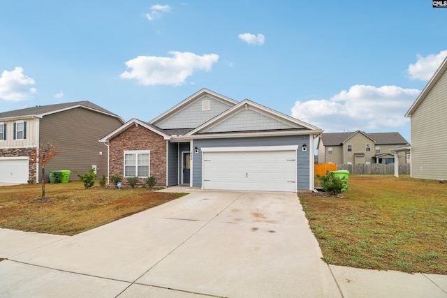 view of front of home with a front yard and a garage