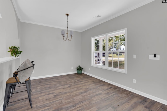 dining space with ornamental molding, an inviting chandelier, and dark wood-type flooring