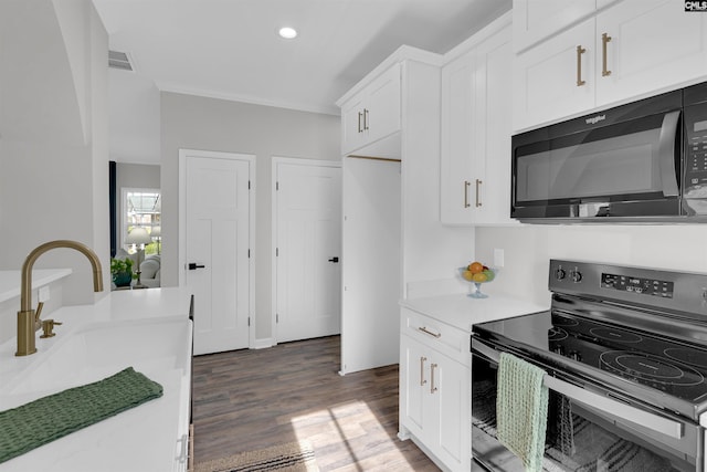 kitchen featuring white cabinetry, dark wood-type flooring, black appliances, and sink