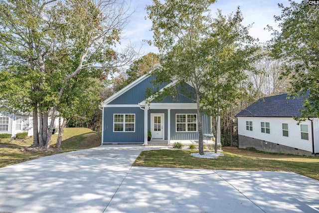 view of front of property with covered porch and a front yard