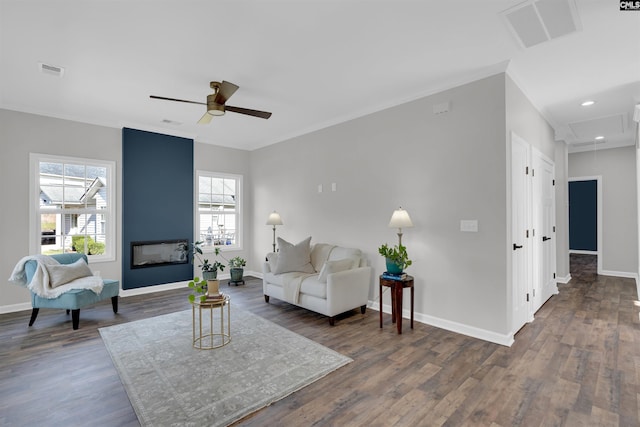 living room with dark hardwood / wood-style flooring, ceiling fan, and plenty of natural light