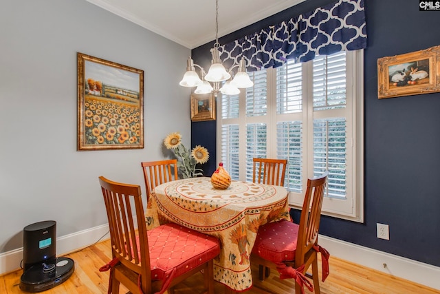 dining area with a chandelier, hardwood / wood-style flooring, and ornamental molding