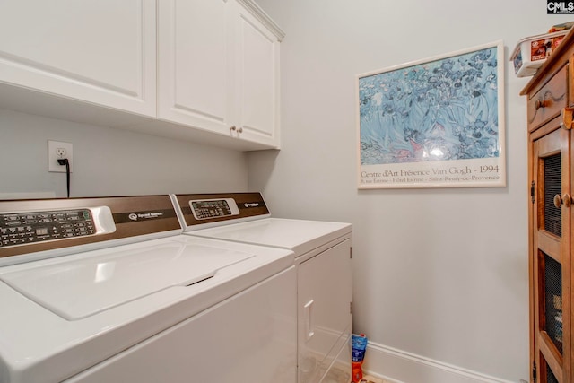 washroom featuring cabinets and washing machine and clothes dryer