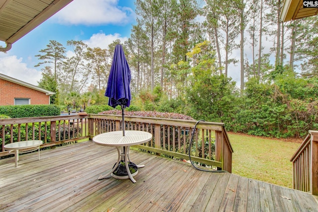 wooden deck featuring a yard