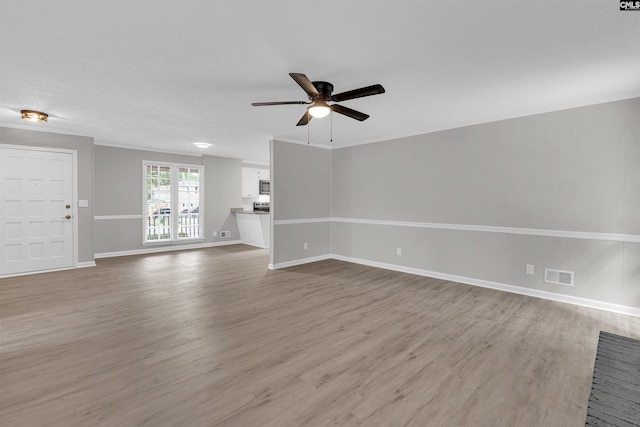 unfurnished living room featuring light wood-type flooring and ceiling fan