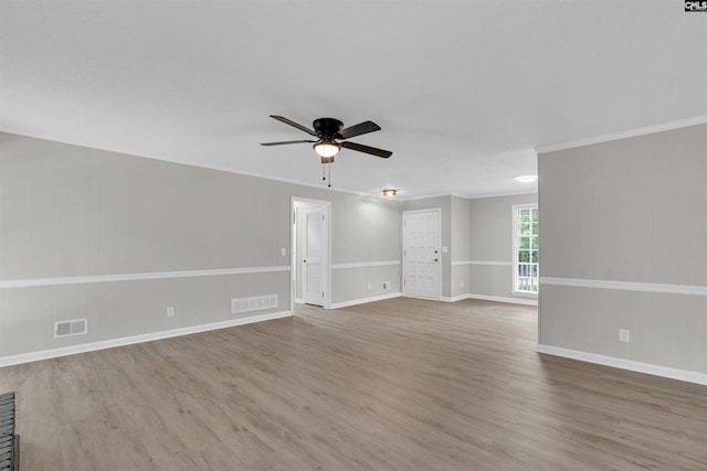 spare room featuring hardwood / wood-style flooring, ceiling fan, and ornamental molding